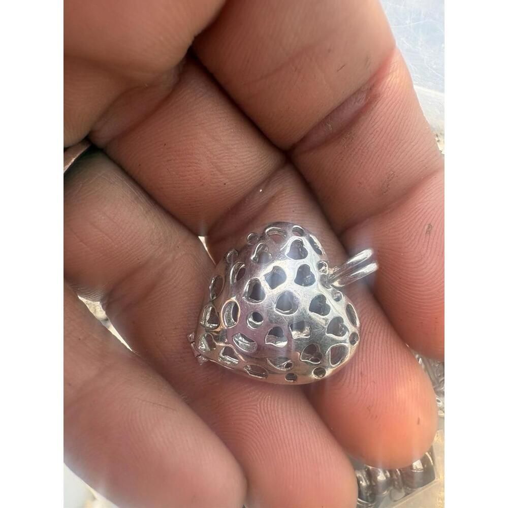 This item is a sterling silver filigree heart cage pendant,